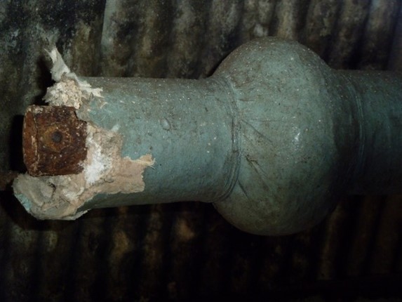 Image showing damaged pipe insulation which has been painted green