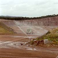 A quarry with a truck in the distance