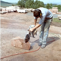 a hose has been connected to the cutter. This supplies water to jets spraying onto the cutting blade