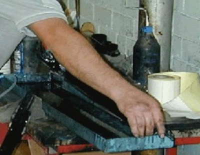 Person handling object on machine