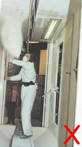 Figure 5 - Worker cleaning spray booth from inside