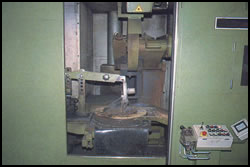 Automatic cut-off machine showing a casting in a fixture